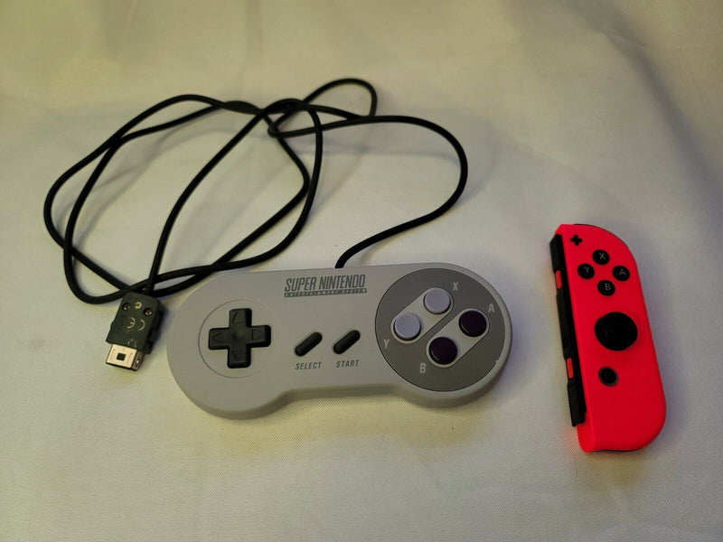 Both Super Nintendo Controller Clv-202 & Orange Joy-Con Right For The Nintendo