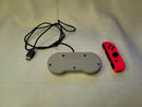 Both Super Nintendo Controller Clv-202 & Orange Joy-Con Right For The Nintendo