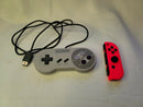 Both Super Nintendo Controller Clv-202 & Orange Joy-Con Right For The Nintendo